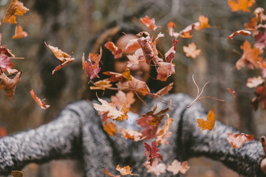Woman-throwing-autumn-leaves-Nature-Connection-Books