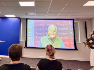Satish Kumar on screen at conference